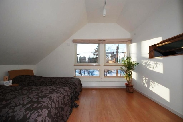 ２階寝室。写真左側の壁の高さは１メートル。コストダウンと空間の有効活用、外観デザイン向上を両立した工夫